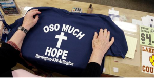 A customer rests her hands on a tee-shirt for sale at an Arlington sporting goods store