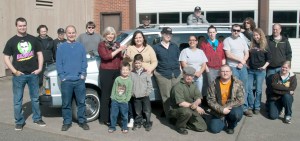 Peninsula College automotive students gather around as Nancy Chambers