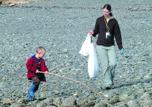 Angela Wade of Port Angeles carries trash bags