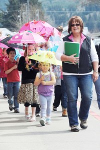Pat Soderlind leads the Umbrella Parade in downtown Forks during the 2012 RainFest. Lonnie Archibald/for Peninsula Daily News