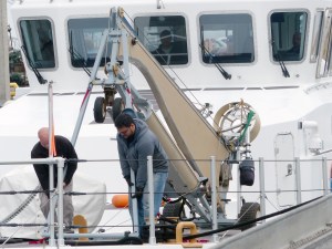 Contract workers install an unmanned-aircraft system aboard Westport Shipyards Solution at Port Angeles Boat Haven. Photo by David G. Sellars/for Peninsula Daily News