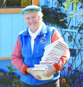 Deborah Morgan-Ellis of Port Angeles is poised to give away 20 free copies of The Alchemist by Paulo Coelho today as part of World Book Night. Diane Urbani de la Paz/Peninsula Daily News