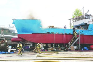 A fire on a commercial fishing vessel is extinguished Monday in the Port Townsend Boat Haven. Crystal Craig