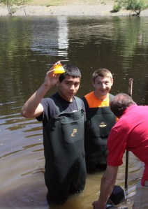 Thomas Blevins of the Port Angeles High School wrestling team holds up the winning duck over 25