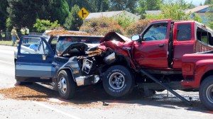 Accident investigators from the Clallam County Sheriff's Office and Sequim Police Department take mesurements at the scene of a collision between two pickup trucks on Old Olympic Highway near Mantle Road northwest of Sequim today. Keith Thorpe/Peninsula Daily News