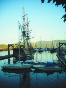 The tall masts of the Lady Washington tower over John Wayne Marina Tuesday night. The replica of the famous ship and Hawaiian Chieftain will perform a mock battle in Sequim Bay. Margaret McKenzie/Peninsula Daily News