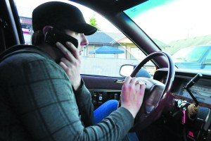 Blue Top Cab driver Christopher Cowell recieves a call from a customer while picking up another. Jesse Major/for Peninsula Daily News