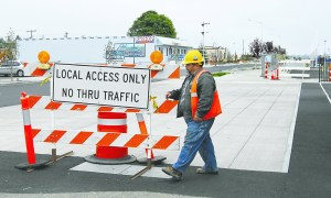 Roland Ordona of Primo Construction prepares to remove a traffic barricade from Railroad Avenue in downtown Port Angeles on Wednesday. Keith Thorpe/Peninsula Daily News