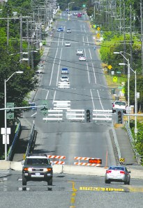 Traffic makes its way along Lauridsen Boulevard in Port Angeles on Tuesday as barricades mark a closed bridge over Peabody Creek. The crossing was barred Monday in preparation for replacement of the aging span. Keith Thorpe/Peninsula Daily News