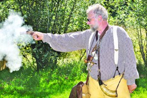 “Mountain man” Charlie Stowe of Black Diamond fires his Monarch 41-caliber black powder derringer at a target during the annual Green River Mountain Men Rendezvous in 2011. Peninsula Daily News