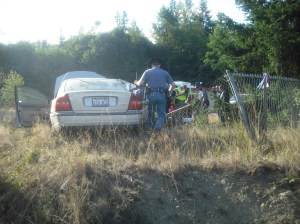 A Washington state trooper examines the Volvo that crashed near Barr Road in Port Angeles Sunday morning