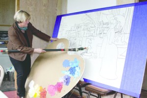 Port Angeles Fine Arts Center Executive Director Robin Anderson grapples with a Paint the Peninsula mural