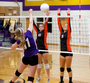 Port Townsend's Sira WInes (10) and Rio Golden (5) try to block a hit by Quilcene's Megan Weller Steve Mullensky/for Peninsula Daily News