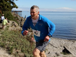 Tom Wahl runs on Hollywood Beach as he switches from the kayak portion of The Big Hurt to the road bike stage last week. Wahl participated in the event less than four months after surgery for prostate cancer. Anita Martin