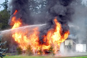 The garage on Regent Street in south Port Angeles is engulfed in flames Wednesday afternoon. Keith Thorpe/Peninsula Daily News