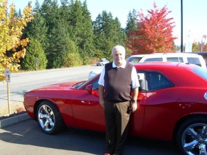 Dan Wilder stands with a Dodge Challenger R/T at his dealership