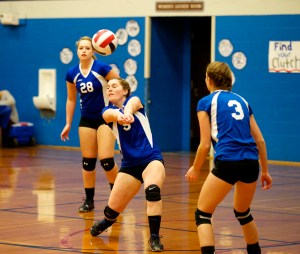 Chimacum's Lauren Thacker (28) and Olivia Baird (3) watch as teammate Taylor Carthum
