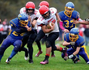 Neah Bay's Phillip Greene (27) runs against Crescent's Luke Leonard (24) and Jakob Baillargeon. Also in on the play are Neah Bay's Reggie Buttram (28) and Crescent's KC Spencer (37). Jeff Halstead/for Peninsula Daily News