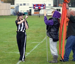 Line Judge Kalia Olin instructs chain gang member Shona Davis to set the down marker