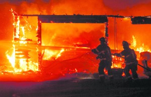 Firefighters battle a blaze that broke out in a garage on South Tiller Road in Port Angeles. Keith Thorpe/Peninsula Daily News