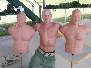 This undated photograph obtained by The Seattle Times shows FBI Special Agent Frederick W. Humphries posing with target dummies following a SWAT practice in an unknown location. The Times says Humphries sent the photograph to friend and Florida socialite Jill Kelley and others