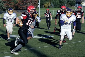 Neah Bay's Cole Svec (16) runs away from Pateros defenders last week in the opening round of the state playoffs.
