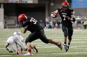 (*Click on gallery below for more photos*) Neah Bay's Cody Cummins (7) runs the ball as Tyler McCaulley (32) blocks against Liberty Christian in the second half of the 1B division high school state championship football game on Saturday. The Associated Press (click on photo to enlarge)