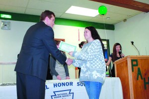 Port Angeles High School junior July Bain shakes Principal Garry Cameron's handas she received her first Academic Bar. Port Angeles School District