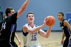 Chimacum's Sam Golden eyes the basket while defended by North Mason's Zac Marks as the Bulldogs' Trey Fisher looks on. Steve Mullensky/for Peninsula Daily News