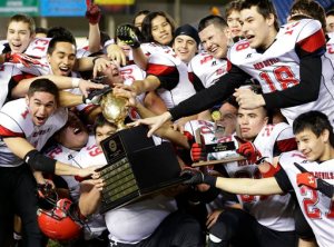 Neah Bay players celebrate with the trophy after they beat Touchet 36-18 in the Class 1B high school football championship game at the Tacoma Dome. Ted S. Warren/The Associated Press