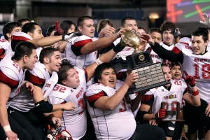 Neah Bay lineman Carl Mack (39) and teammates Mitchell McGee (21)