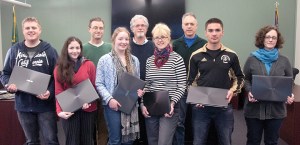 Holding their new laptops are honors program students