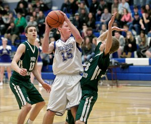 Chimacum's Sam Golden (15) runs into Port Angeles' Janson Pederson as Luke Angevine (13) looks on. Steve Mullensky/for Peninsula Daily News