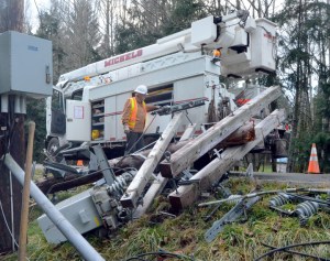 Lineman Larry Duggins is part of a crew that will be working around the clock to repair a power pole on state Highway 116. The wind-related destruction cut off power to Marrowstone Island's 800 residents