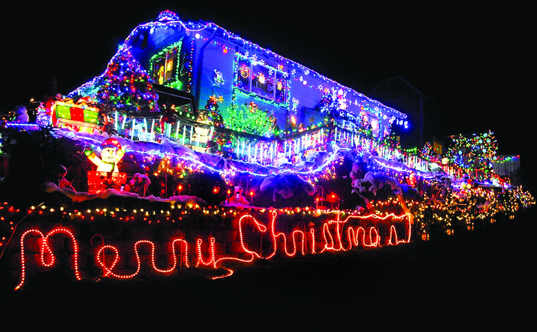 This house in the 700 block of South Chambers Street stands like a beacon of color in the Port Angeles night. Keith Thorpe/Peninsula Daily News