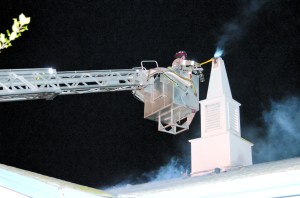 A firefighter puts out the blaze at First Baptist Church of Sequim on Tuesday night. Patrick Young/Clallam County Fire District No. 3