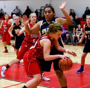 Port Townsend's Reilly Berkshire maneuvers in the post against Bainbridge's Malia Peato. Steve Mullensky/for Peninsula Daily News