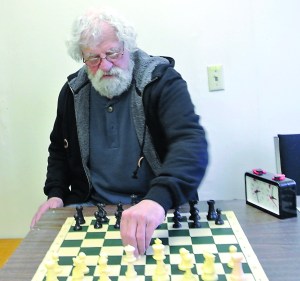 Dennis McGuire of the Last Exit on Kearney Chess Club demonstrates some moves that could be used in the annual tournament that begins this week. Prizes will be paid out to the top 10 participants. Charlie Bermant/Peninsula Daily News
