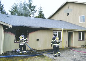 Firefighters from Port Ludlow Fire and Rescue battle a blaze in an office on Colwell Street in Port Hadlock on Saturday. They were assisted by East Jefferson Fire-Rescue and Naval Magazine Indian Island firefighters. — Bill Beezely/East Jefferson Fire-Rescue