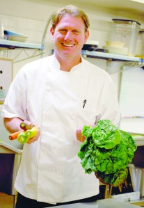 Arran Stark holds items grown at Nashs Organic farm.  -- Photo by Diane Urbani de la Paz/Peninsula Daily News