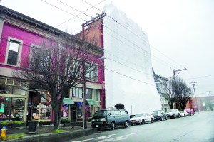 The replacement of the Eisenbeis Buildings facade  now covered to protect workers from the weather  is expected to take three to four months. -- Photo by Charlie Bermant/Peninsula Daily News