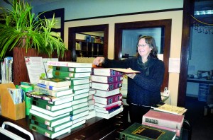 Port Townsend Library collections manager Beverly Moore catalogs some of the books that will need to be stored in anticipation of the librarys move back into the Carnegie Building