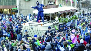 Seattle Seahawks running back Marshawn Lynch throws Skittles to fans during the parade for the NFL Super Bowl champions Wednesday in Seattle.  Steve Ringman/The Seattle Times