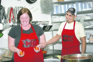 Angee Garcia prepares to juggle a couple of tomatoes as her husband Jose watches.  -- Photo by Diane Urbani de la Paz/Peninsula Daily News