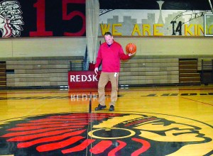 Port Townsend High School Athletic Director Scott Wilson inspects the Redskins logo on the floor of the high school gym.  Charlie Bermant/Peninsula Daily News