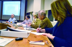 Sequim School Board members sign a resolution at Tuesday nights board meeting to put a construction bond measure on the April 22 ballot. From left are President John Bridge
