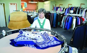 Long-time worker Janet Littlefield shows off a hat in the Museum & Arts Centers Second Chance Consignment Shop at 155 W. Cedar St. The hat and everything else in the store will be on sale for $1 for the next week until the store closes for good Feb. 25.  Joe Smillie/Peninsula Daily News