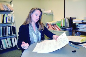 Jefferson County Planning Director Stacie Hoskins inspects some of the applications for marijuana operations in the unincorporated parts of the county.  Photo by Charlie Bermant/Peninsula Daily News