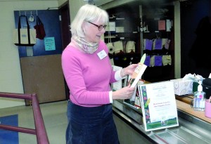Port Townsend Librarian Cris Wilson adjusts the display promoting this years Community Read with Atina Diffleys Turn Here Sweet Corn.  Charlie Bermant/Peninsula Daily News