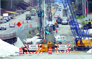 Traffic on U.S. Highway 101 transitions from the old roadway to a new section of road near the site where a second new bridge is being built over McDonald Creek between Port Angeles and Sequim.  Keith Thorpe/Peninsula Daily News